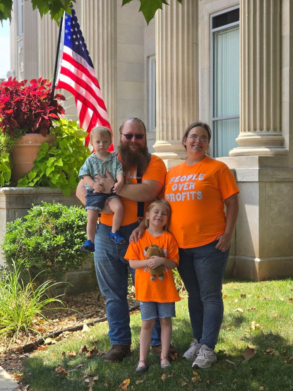 Clayton with his family wearing People Over Profits shirts